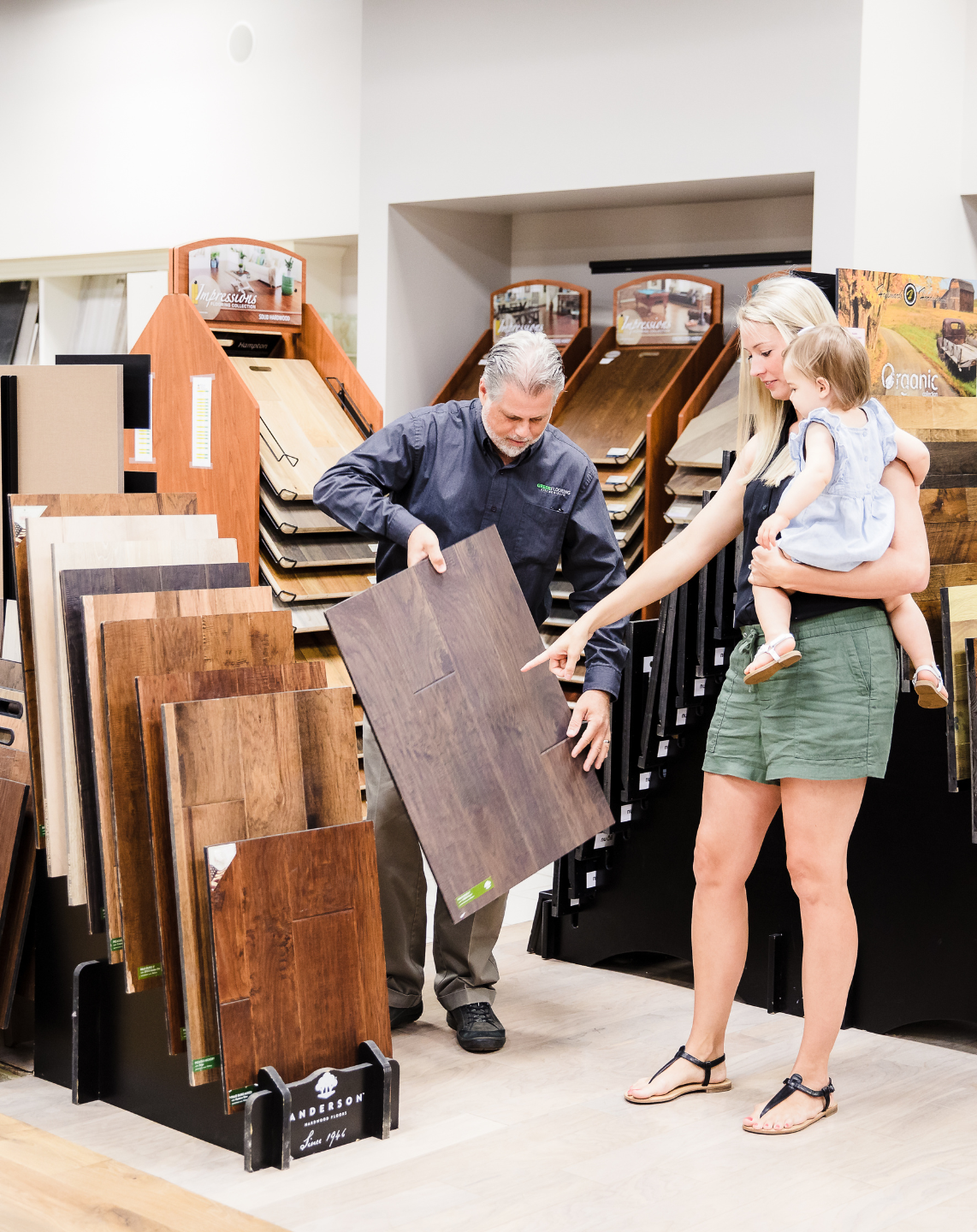 Greer's employee showing customer luxury vinyl samples