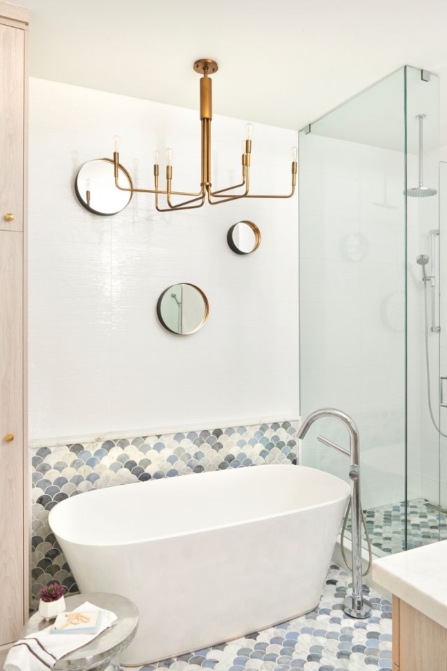 Unique clam shaped tile in bathroom with white and blue